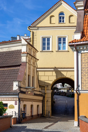 Lublin, Poland - May 24, 2022: Colorful tenement houses and Grodzka Gate, remains of the defensive...