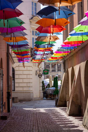 Tarnow, Poland - July 24, 2021: Piekarska street near Town Square decorated with colorful umbrellas, modeled on the Portuguese "Umbrella Sky" design.のeditorial素材