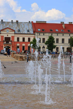 Olkusz, Poland - June 9, 2021: Market square in a small town near Krakow, colorful houses and a fountainのeditorial素材