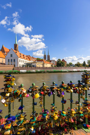 Wroclaw, Poland - September 30, 2021: Railing on the Odra River with love locks, view of Ostow Tumski and towers of Wroclaw Cathedralのeditorial素材