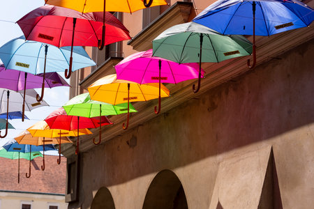 Tarnow, Poland - July 24, 2021: Piekarska street near Town Square decorated with colorful umbrellas, modeled on the Portuguese "Umbrella Sky" design.のeditorial素材