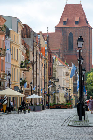 Torun, Poland - June 27, 2020: View from Old Town Square to Zeglarska Street and Torun Cathedral