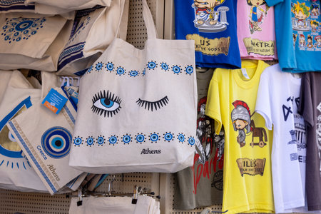 Athens, Greece - October 19, 2022: Typical souvenir shop on a street in the famous district of Plaka, fabric bags with patterns, eye of prophetのeditorial素材