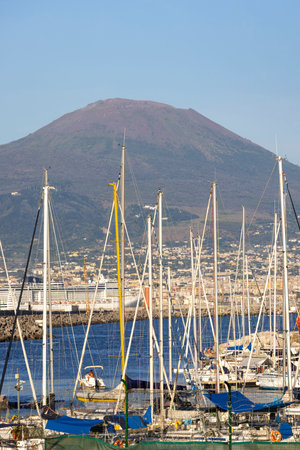Naples, Italy - June 26, 2021: View of the port for boats and yachts on the boulevard in Chiaia. Mount Vesuvius volcano in a background.のeditorial素材