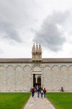 Pisa; Italy - May 13; 2019: People in front of Camposanto Monumentale, monumental medieval cemetery. It is part of the Piazza del Duomo with the cathedral, baptistery and the Leaning Tower.のeditorial素材