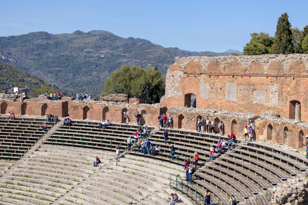 Taormina, Sicily, Italy - April 28, 2023: Ancient theater of Taormina (Teatro antico di Taormina), ruins of ancient Greek theatre, built in Hellenistic era with a view of Mount Etna volcanoのeditorial素材