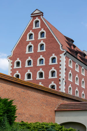 Torun, Poland - June 27, 2020: Decorative facade of Old Granary and defensive old City Walls