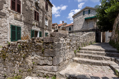 A narrow street in the Old Town near the Old Walls. Typical architecture of Mediterranean cities, Kotor, Montenegroの写真素材