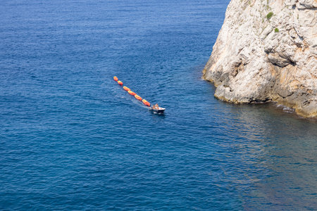 Dubrovnik, Croatia - June 27, 2023: Transportation of colorful kayaks for tourists by water on the Adriatic Sea to the West Harbour next to Fort Lovrijenac and City Wallsのeditorial素材