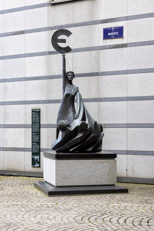 Brussels, Belgium - May 16, 2023: Bronze statue of Europe with Greek epsilon, euro currency symbol in front of the modern building of the European Parliament, the seat of EUのeditorial素材
