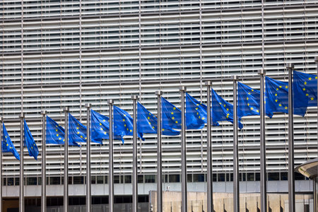 Brussels, Belgium - May 18, 2023: Blue flags of Europe in front of Berlaymont, seat of the European Commission. The building is located at the Robert Schuman Roundaboutのeditorial素材