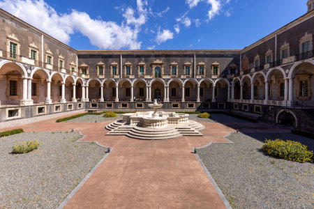 Catania, Sicily, Italy - April 26, 2023: Medieval Benedictine Monastery of San Nicolo l'Arena, courtyard and fountain, now University of Cataniaのeditorial素材