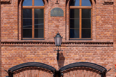 Lodz, Poland - May 4, 2023: Red brick facade of restored building in urban complex Ksiezy Mlyn (Priest's Mill). It was the biggest textile factory in the city in the 19th centuryのeditorial素材