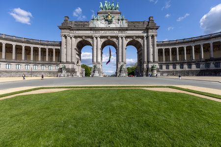 Brussels, Belgium - May 16, 2023: Central Cinquantenaire arch and U-shaped arcade in Cinquantenaire Park. Rainbow flag (LGBT) flies on the buildingのeditorial素材