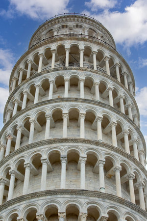 Pisa, Italy - Leaning Tower of Pisa on a background of blue sky. It is famous medieval freestanding...