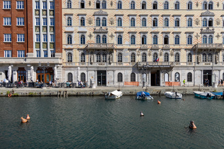 Trieste, Italy - September 26, 2023: View of Grand Canal (Canal Grande Trieste) with moored boats on...