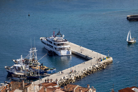 Rovinj; Croatia; Istria - September 29; 2023: Aerial view from bell tower of Saint Euphemia Church of port.Typical red ceramic roof tile and pier with a moored shipのeditorial素材
