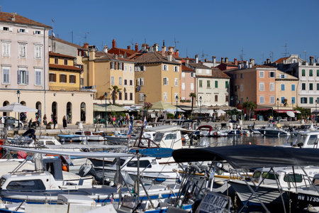 Rovinj, Croatia, Istria - September 29, 2023: Colorful tenement houses on the boulevard by the South port Rovinj over Adriatic Sea, moored boatsのeditorial素材