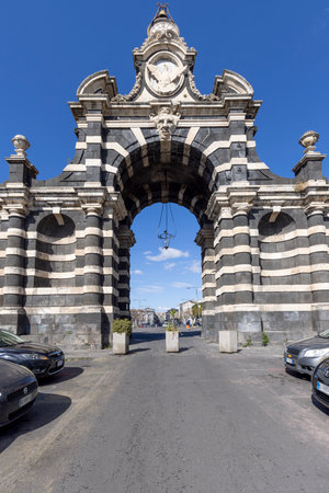 Catania, Sicily, Italy - April 26, 2023: 18th century triumphal arch Porta Garibaldi. It is made of alternating white stone from Syracuse and dark blocks of volcanic lava from Mount Etnaのeditorial素材