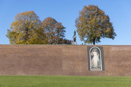 Czestochowa, Poland - October 18, 2024: Tower of Jasna Gora Basilica (Light Mountain) and red brick Jasna GÃ³ra embankments with image of Jesus with an inscription: Jesus, I trust in Youのeditorial素材