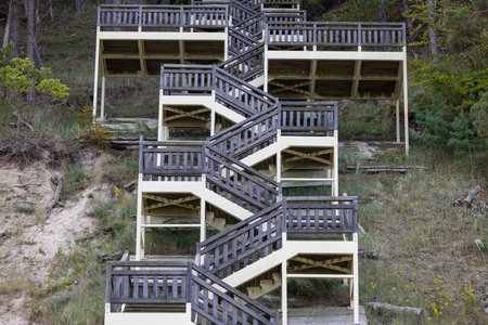 Stairs leading from the sandy beach on Baltic Sea to Kawcza Hill in Wolin National Park,...