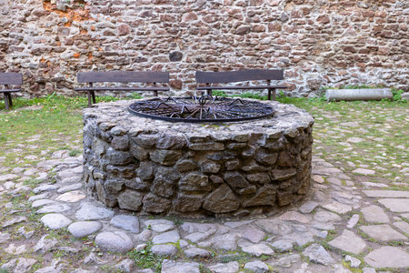 Zagorze Slaskie, Grodno, Poland - October 1, 2021: Medieval Grodno Castle, courtyard with stone wellのeditorial素材