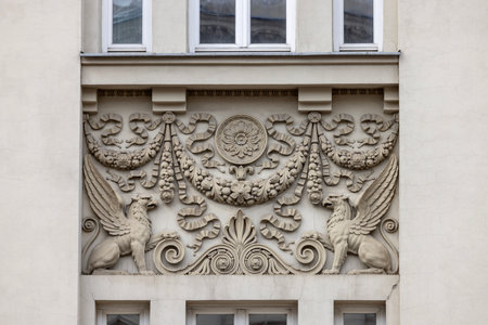 Lublin, Poland - May 24, 2022: Relief on facade of 20th century tenement house on Krakowskie PrzedmieÅcie street. Since its construction, it has always been seat of banksの写真素材