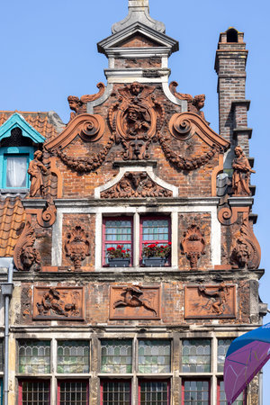 Ghent, Belgium - May 19, 2023: Relief of decorative facade of historic tenement house next to Zuivelbrug bridge by Lys river (Leie) at Kraanlei streetのeditorial素材