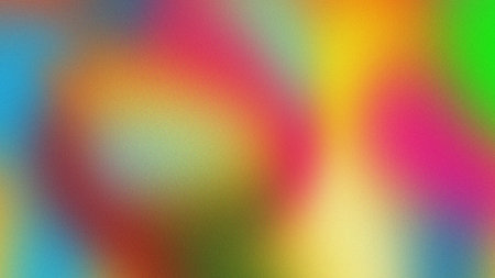 A vibrant and abstract background featuring a smooth gradient of multiple colors including blue, pink, yellow, orange, green, and red. The image has a subtle grainy texture, giving it a soft, artistic, and modern feel. The colors blend seamlessly, creating a visually appealing and dynamic backdrop suitable for various design applications.の写真素材