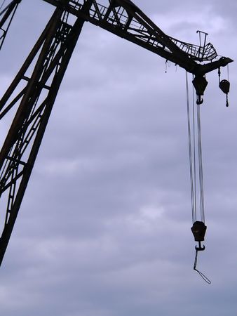 The hoisting crane against the sky.の写真素材