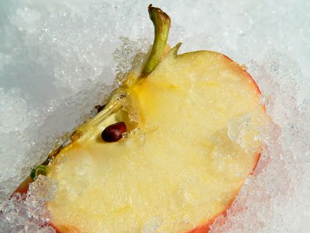 The piece of apple on the snow.の写真素材