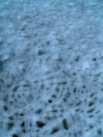 The porous ice on a lake in winter.