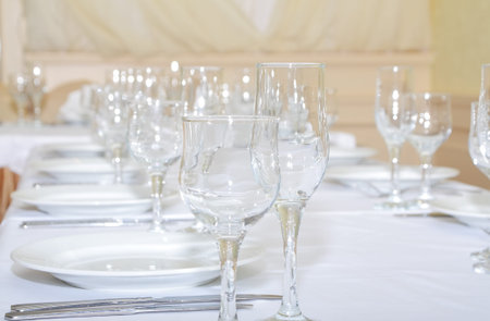 The served restaurant table with wine-glass.