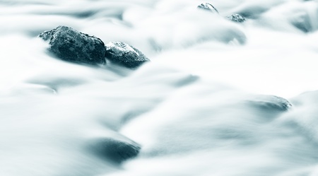 The waterfall on a river in winter.の写真素材