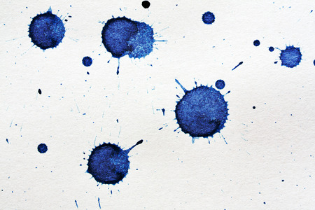 ink blot on a textured paperの写真素材
