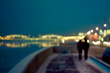 defocused image of a night city life: lovers, boke, traffic lightsの写真素材