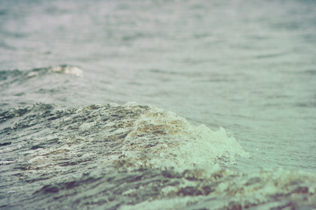 sea wave close up, low angle view, cross processing effectの写真素材