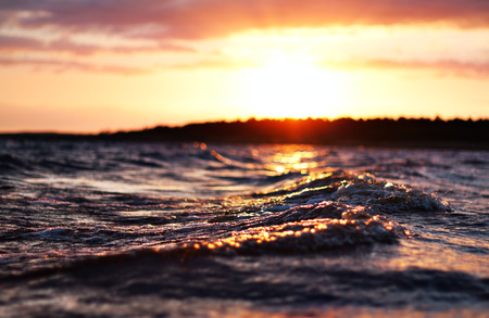 sea wave close up at sunset, low angle view, cross processing effectの写真素材