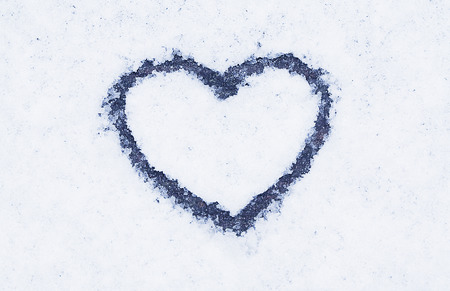 shape of heart on a snow surfaceの写真素材