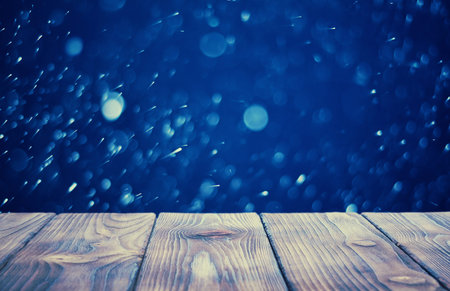 wooden desk and blurred christmas backgroundの写真素材