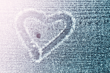 shape of heart on a frozen wooden board in the morningの写真素材