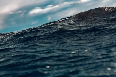 sea wave close up against the sky in the storm, low angle viewの写真素材