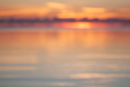beautiful sunset over the ocean, natural blurred backgroundの写真素材