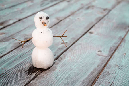 snowman on a wooden table with copy spaceの写真素材