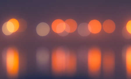 blurred background, defocused street lamps and reflection on a water, natural photo imageの写真素材