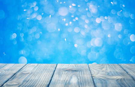 wooden desk and blurred christmas backgroundの写真素材