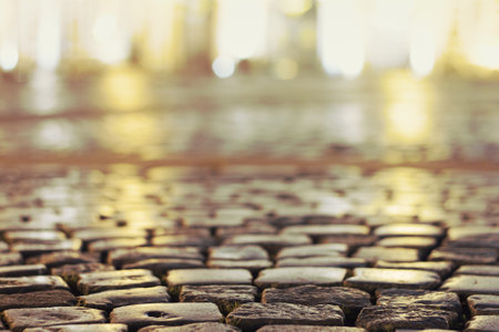 cobblestone pavement on a square with defocused background in the eveningの写真素材