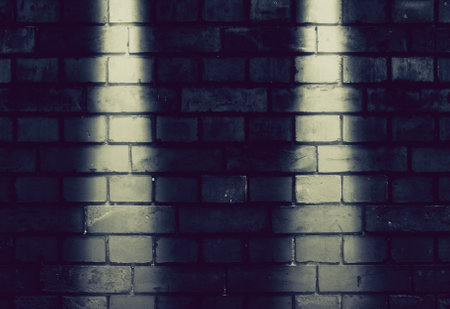 fragment of a brick wall with street lamp lights, vintage effectの写真素材