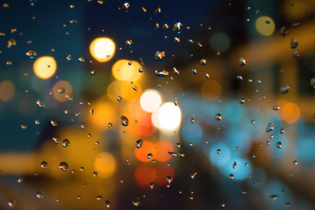 Rain drops and blurred bokeh night light  backgroundの写真素材