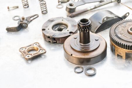 Motorcycle engine parts are separated, cleaned, dried in the sun, waiting for assemblyの写真素材